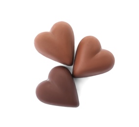 Photo of Tasty heart shaped chocolate candies on white background, top view. Valentine's day celebration