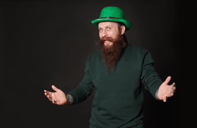 Bearded man in green hat on black background. St. Patrick's Day celebration