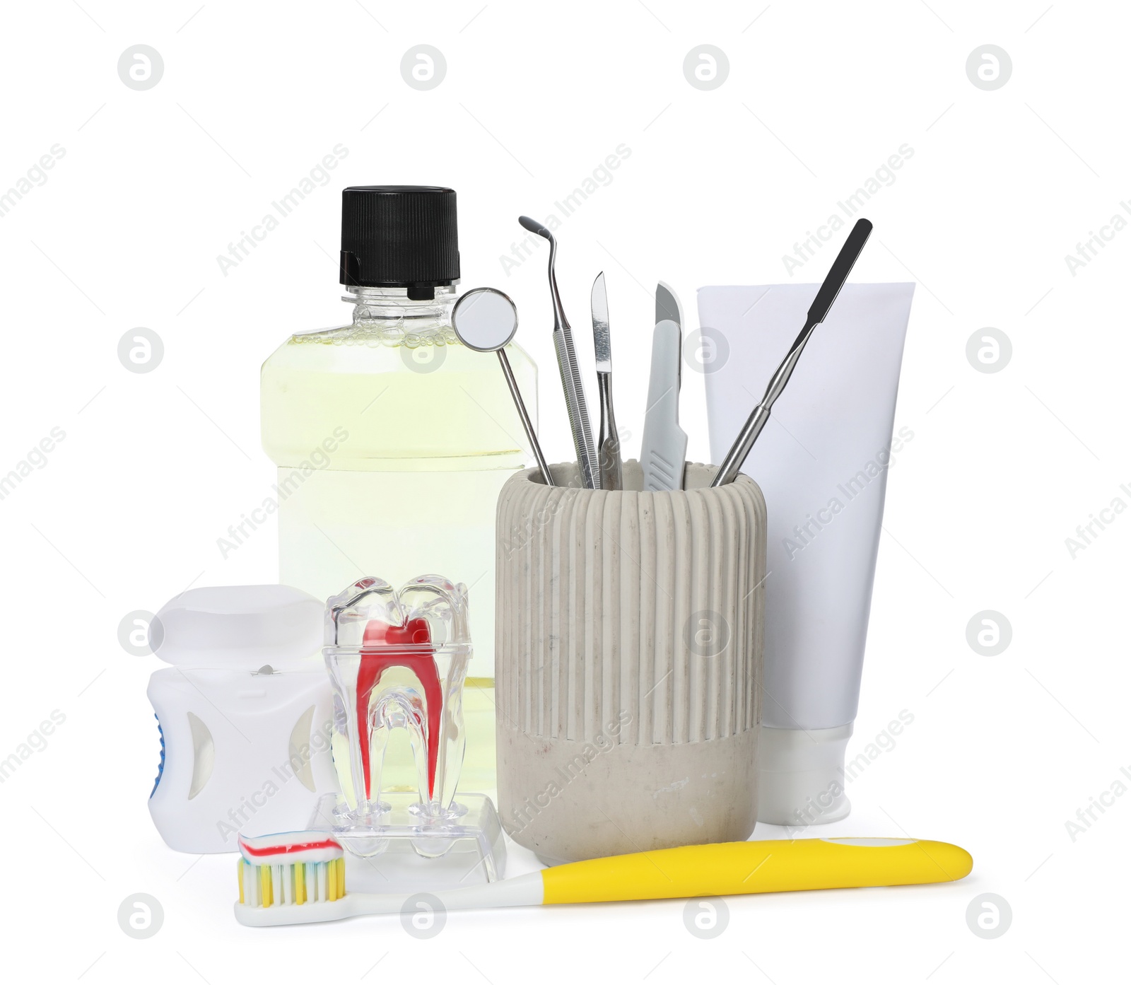 Photo of Tooth model, oral hygiene products and dentist tools on white background