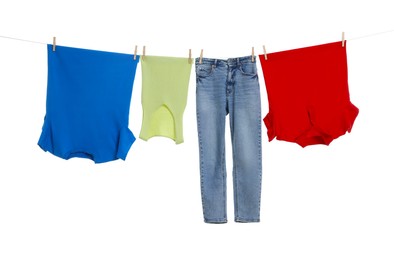 Photo of Different clothes drying on laundry line against white background