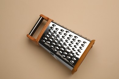 Modern grater on beige background, top view