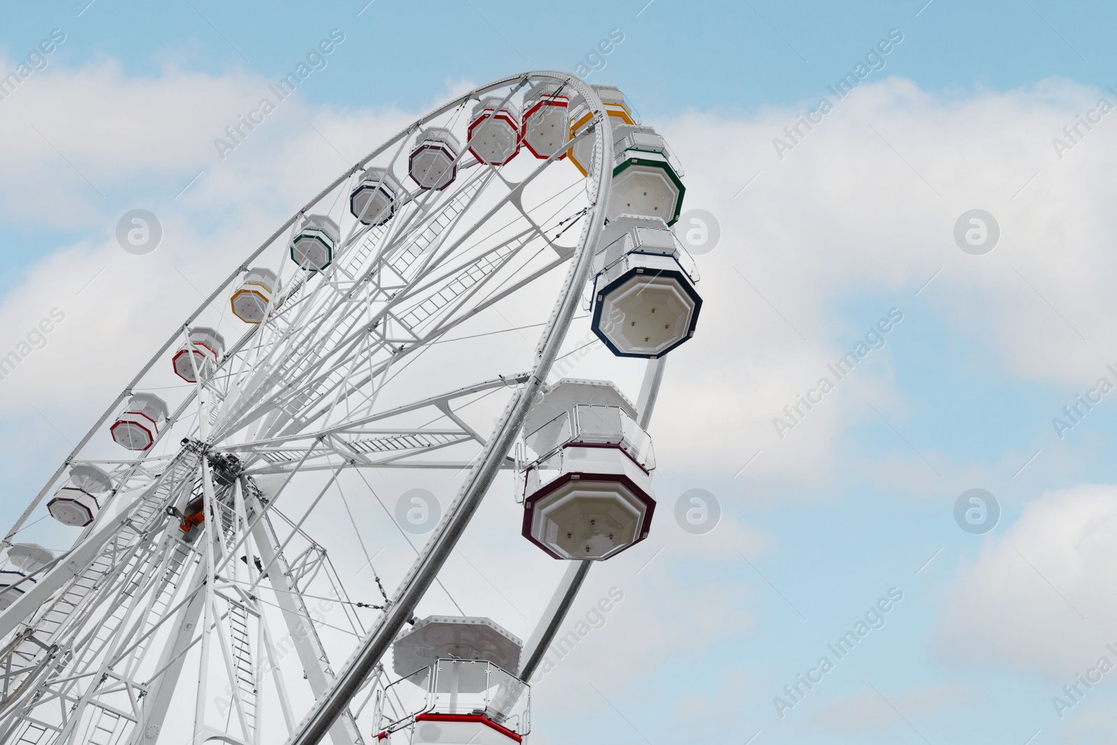 Photo of Large white observation wheel against sky, low angle view. Space for text