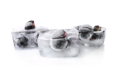 Photo of Fresh berries frozen in ice cubes on white background