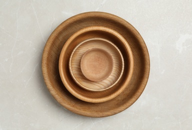 Photo of Wooden bowls on grey table, top view. Cooking utensils