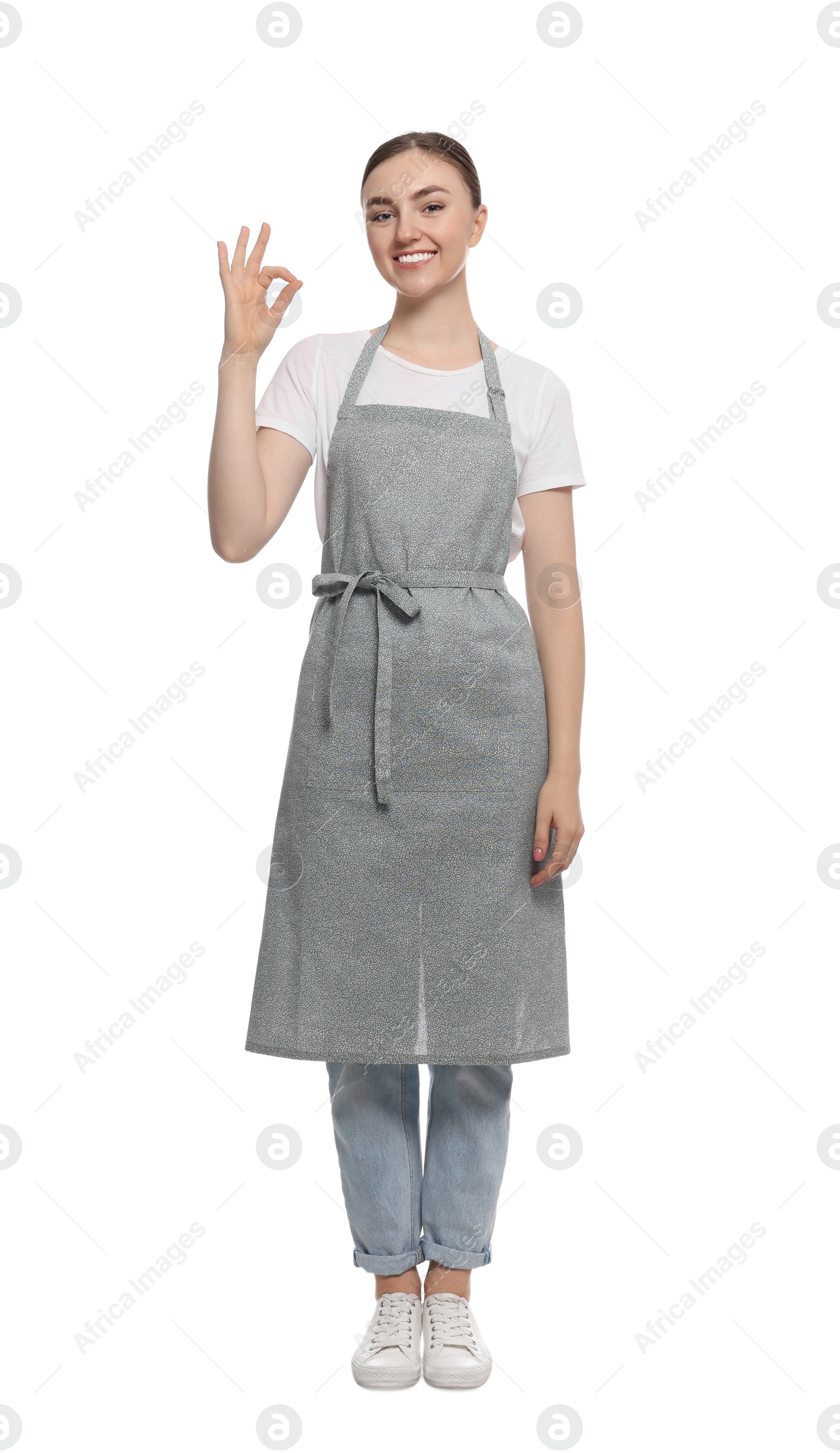 Photo of Beautiful young woman in clean apron on white background