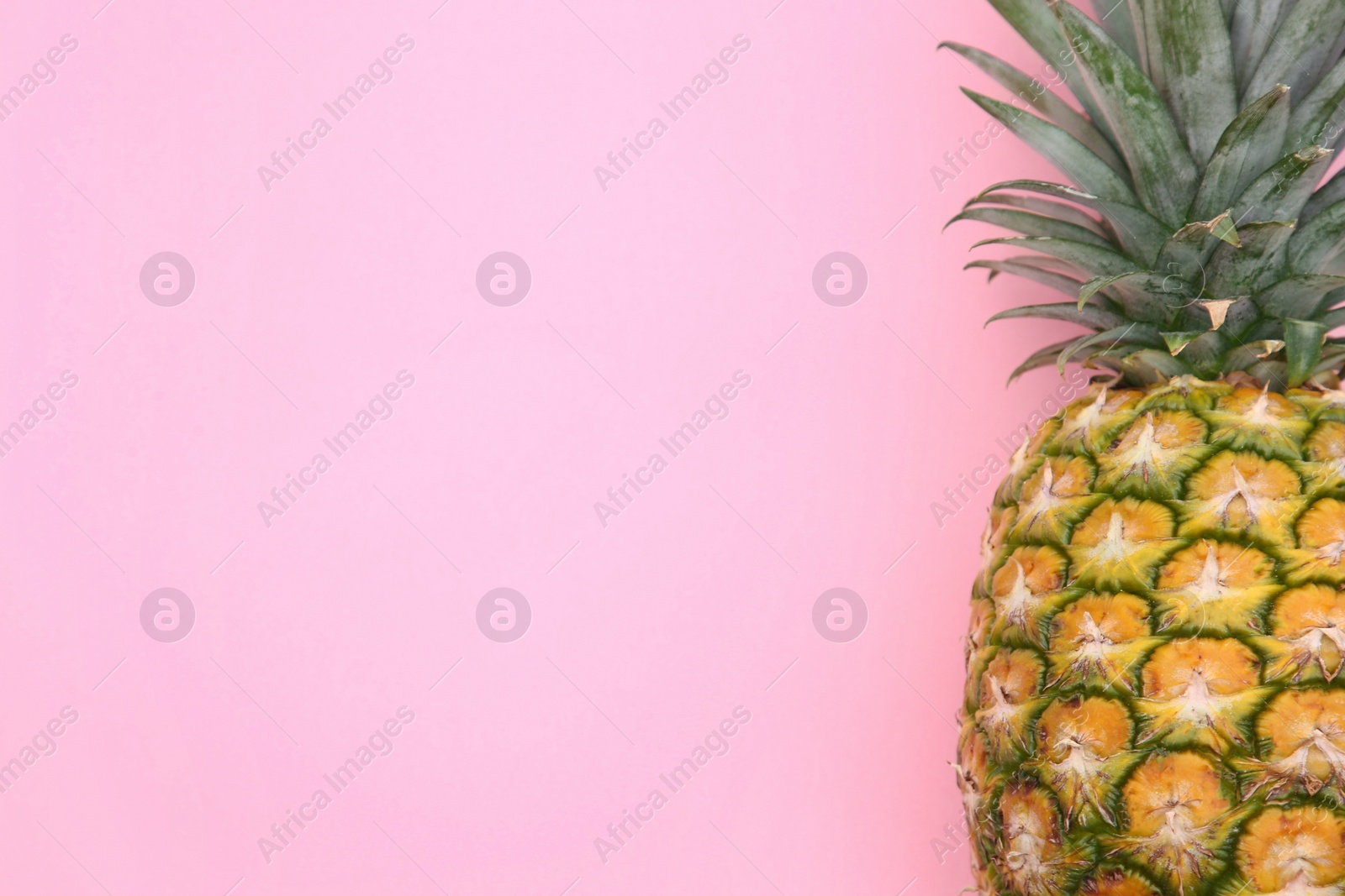 Photo of Delicious ripe pineapple on pink background, top view. Space for text