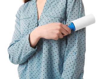 Photo of Young woman cleaning blouse with lint roller on white background