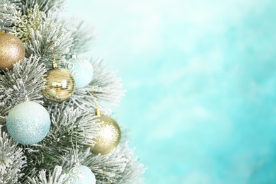 Photo of Beautiful Christmas tree with decor against light blue background. Space for text