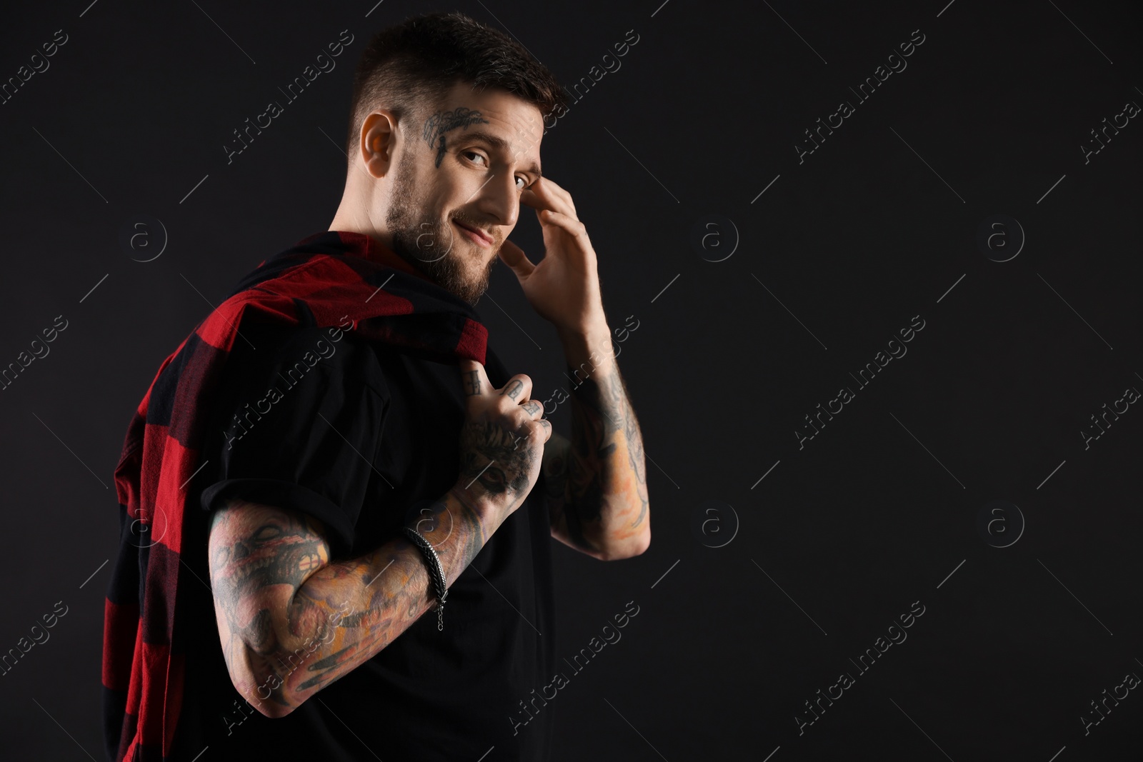 Photo of Portrait of handsome hipster man on black background. Space for text