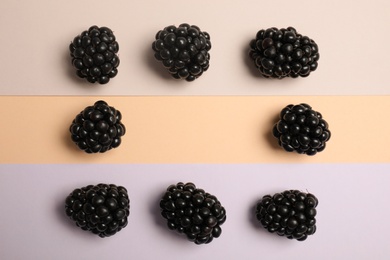 Photo of Flat lay composition with ripe blackberries on color background