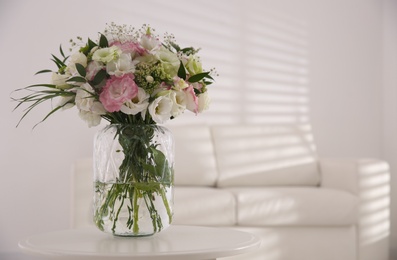 Photo of Bouquet of beautiful flowers on table in living room, space for text. Interior design