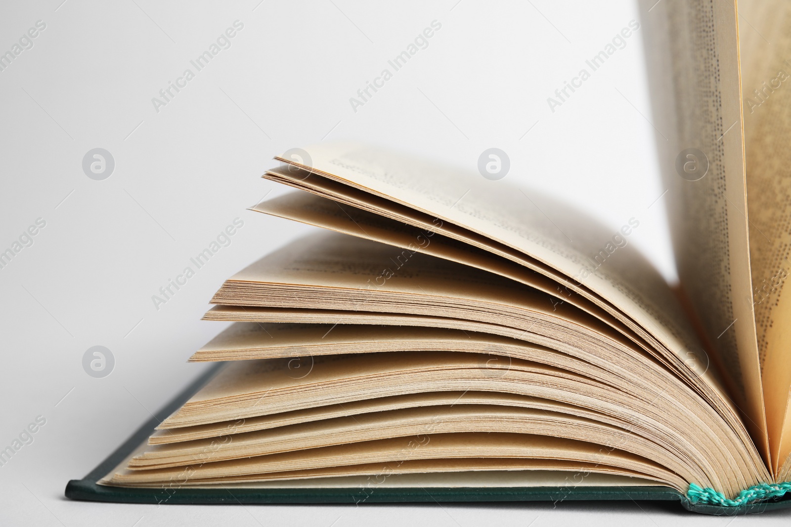 Photo of Closeup view of open book on white background