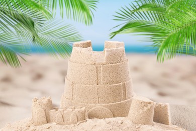 Image of Sand castle on ocean beach, closeup. Outdoor play