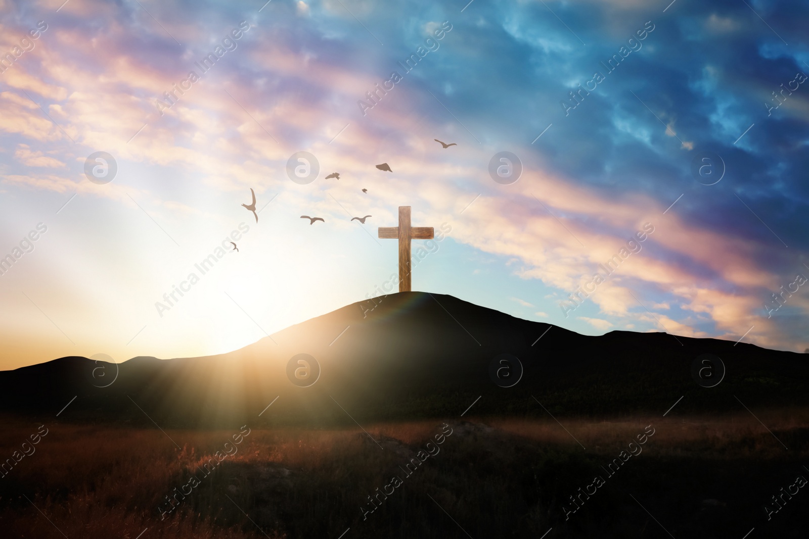 Image of Christian cross on hill outdoors at sunrise. Resurrection of Jesus