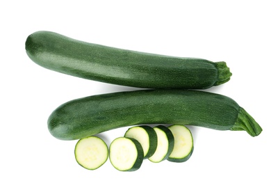 Photo of Cut and whole green ripe zucchini isolated on white, top view