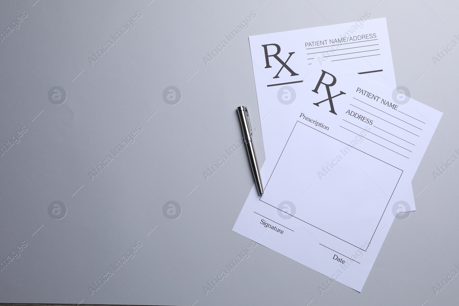 Photo of Medical prescription forms and pen on light grey background, flat lay. Space for text