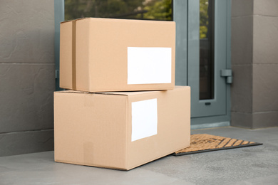 Cardboard boxes near door. Parcel delivery service