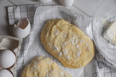 Dough, eggs and flour on white wooden table, flat lay. Cooking ciabatta