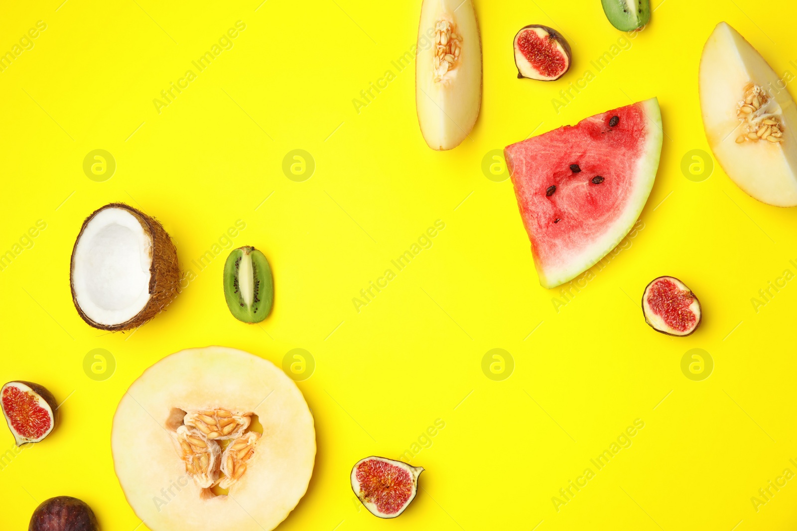 Photo of Flat lay composition with melon, other fruits and space for text on color background