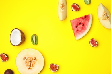 Photo of Flat lay composition with melon, other fruits and space for text on color background