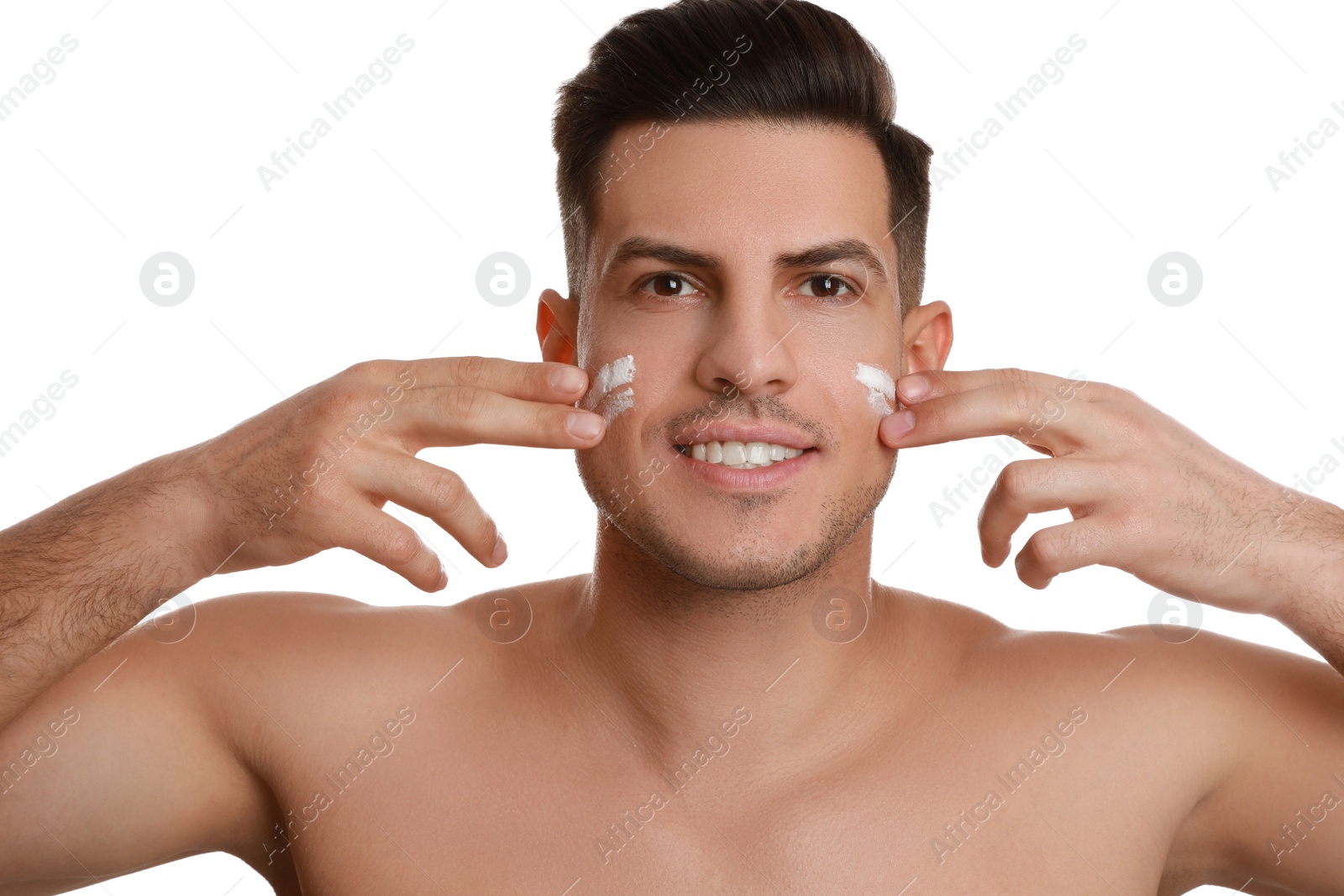 Photo of Handsome man applying face cream on white background