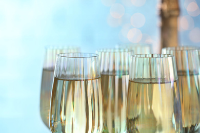 Photo of Glasses of champagne on blurred background, closeup