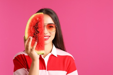 Photo of Beautiful young woman posing with watermelon on color background