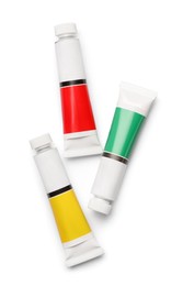 Tubes with oil paints on white background, top view