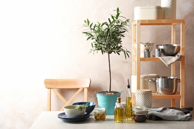 Photo of Fresh olive oil and kitchen utensils on table