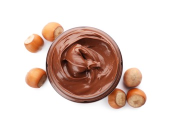 Photo of Glass jar of chocolate paste with hazelnuts on white background, top view