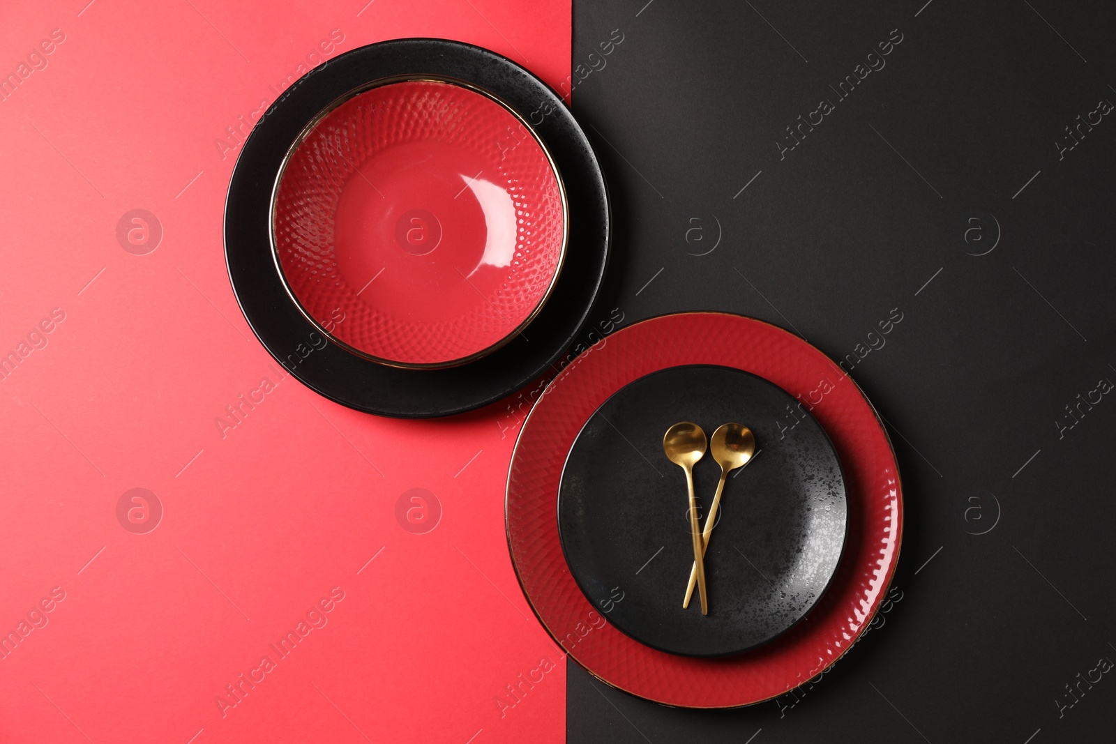 Photo of Stylish table setting with plates and spoons on color background, top view