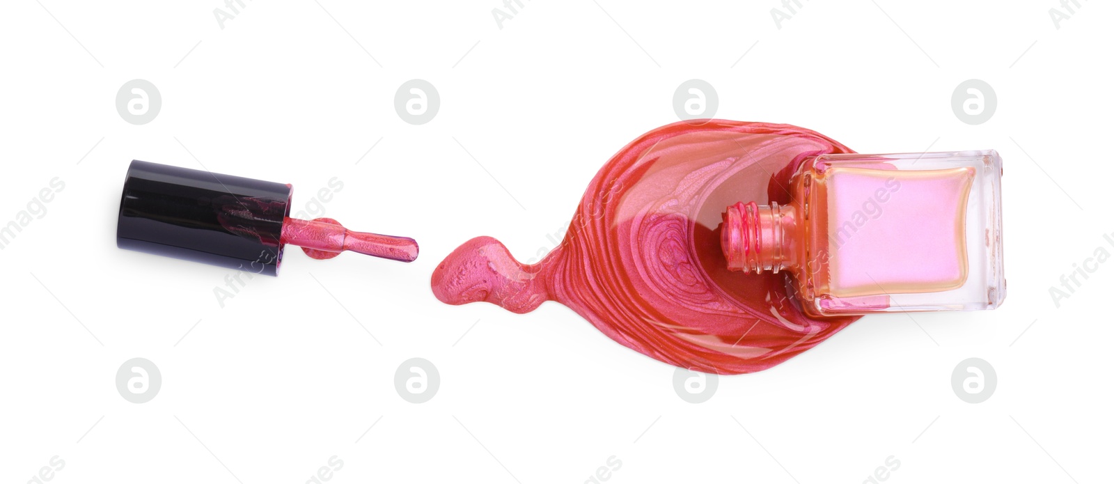 Photo of Overturned bottle of bright nail polish and brush isolated on white, top view