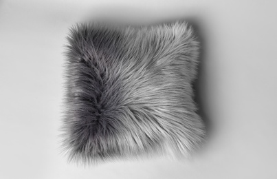 Fluffy decorative pillow on light background