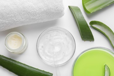 Flat lay composition with cosmetic products and cut aloe leaves on white background