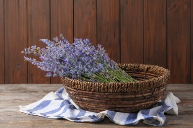 Photo of Bowl with lavender flowers on wooden table