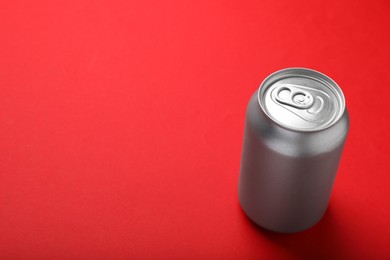 Photo of Can of energy drink on red background. Space for text