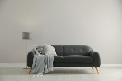 Photo of Stylish comfortable sofa in room. Interior design