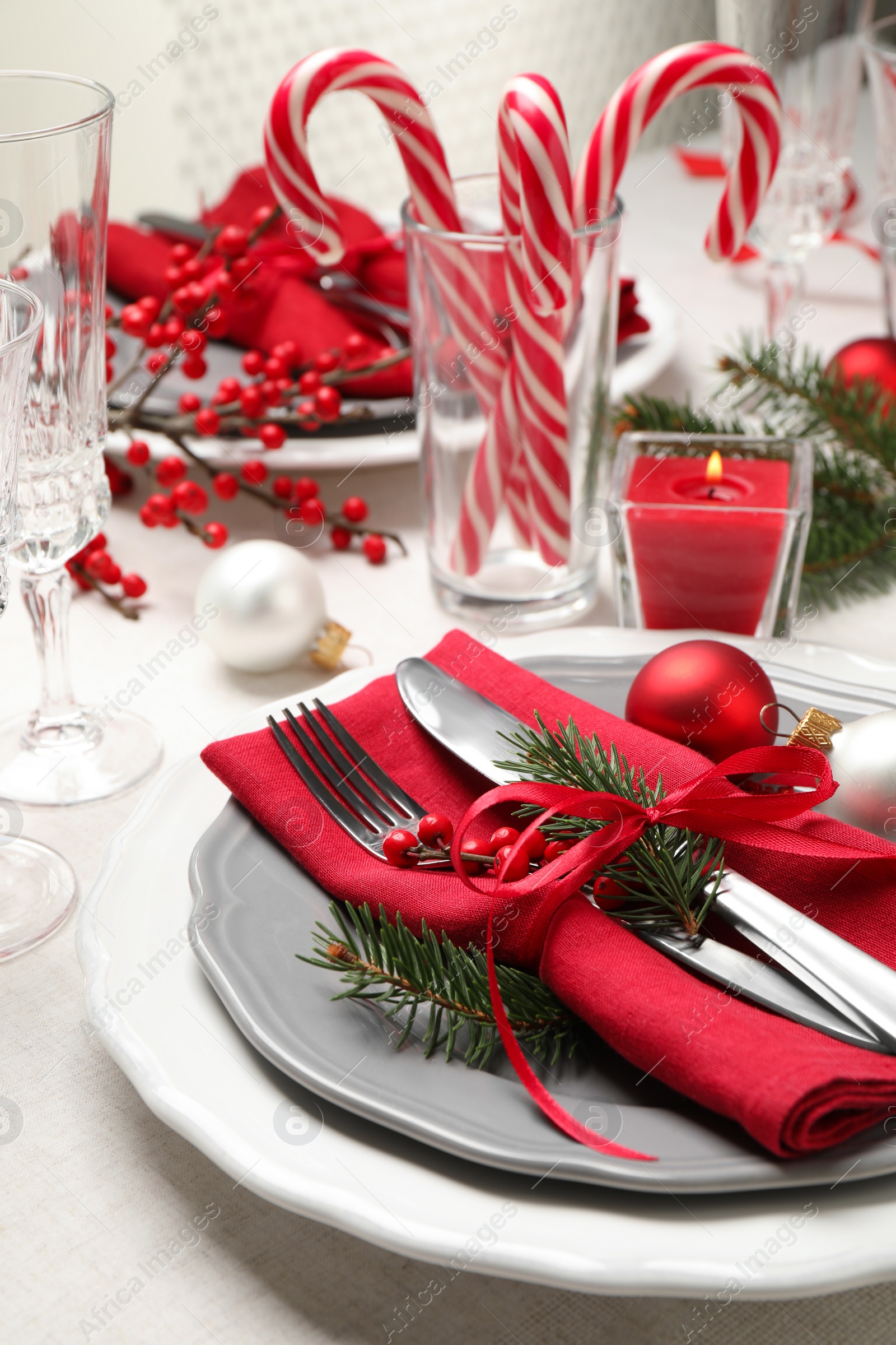 Photo of Festive table setting with beautiful dishware and Christmas decor on white background