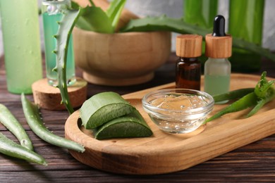 Homemade aloe gel and fresh ingredients on wooden table, closeup