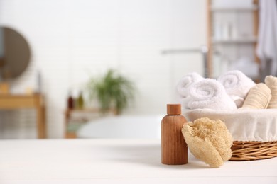 Photo of Composition with spa cosmetic product on white table in bathroom, space for text