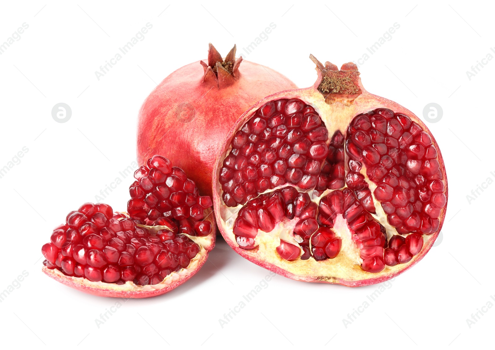 Photo of Cut and whole pomegranates isolated on white