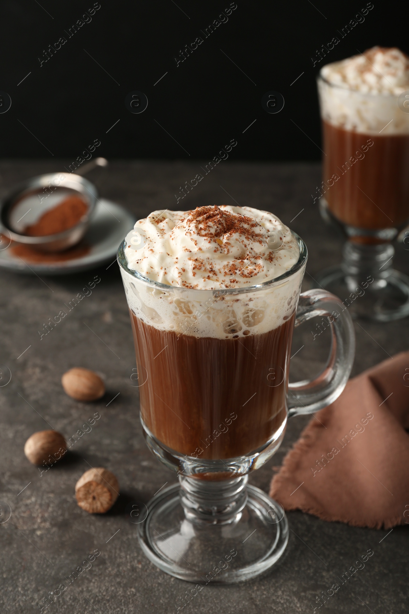 Photo of Hot drink with nutmeg powder on grey table