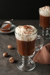 Photo of Hot drink with nutmeg powder on grey table