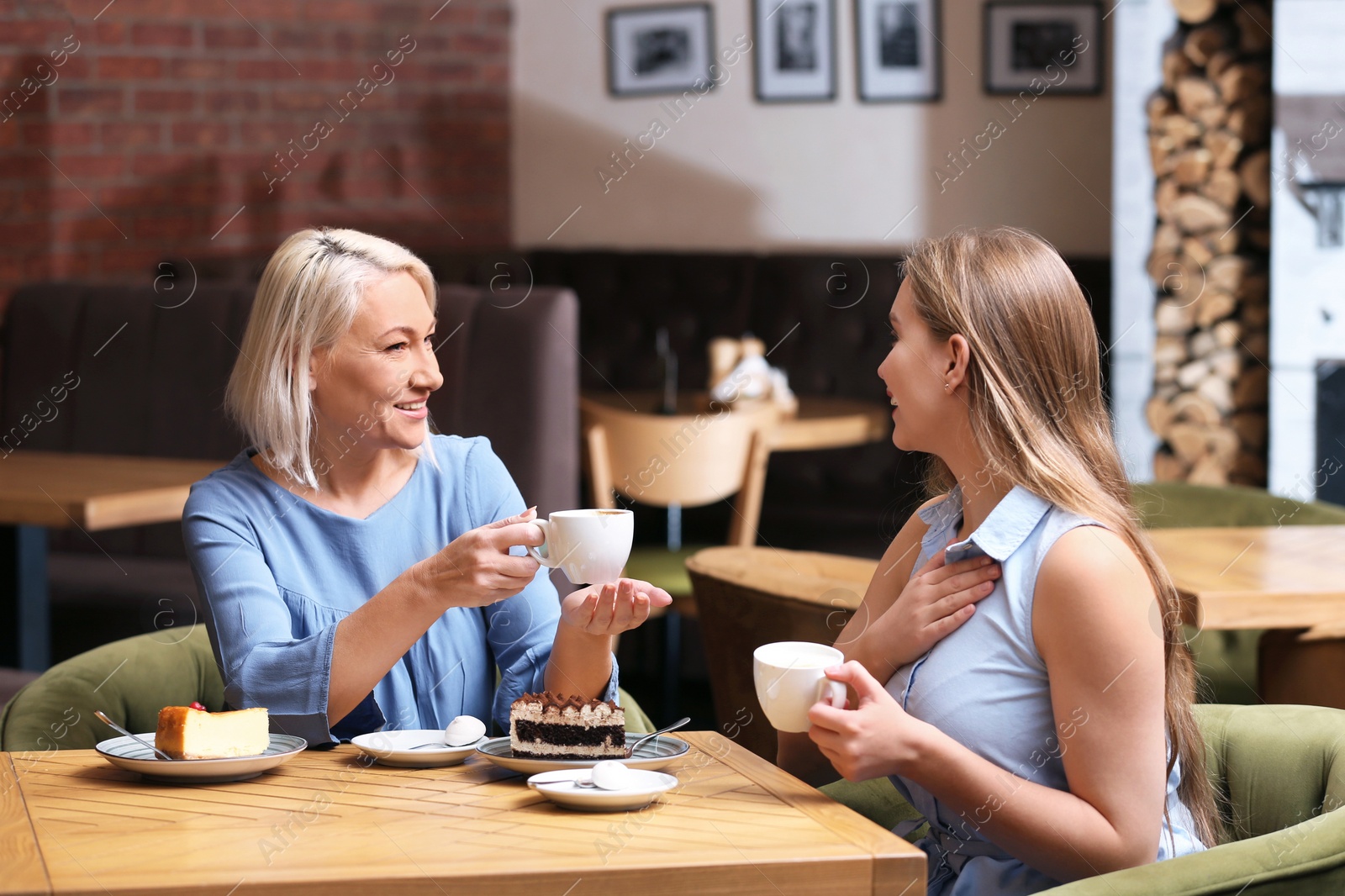 Photo of Mother and her adult daughter spending time together in cafe