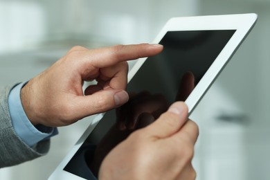 Closeup view of man using new tablet indoors