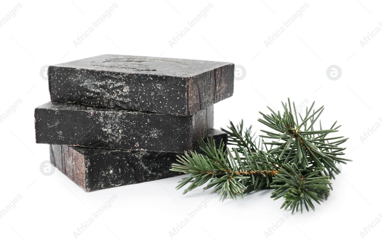 Photo of Handmade soap bars and fir branch on white background