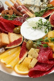 Set of different delicious appetizers on plate, closeup