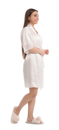 Young woman in silk robe on white background