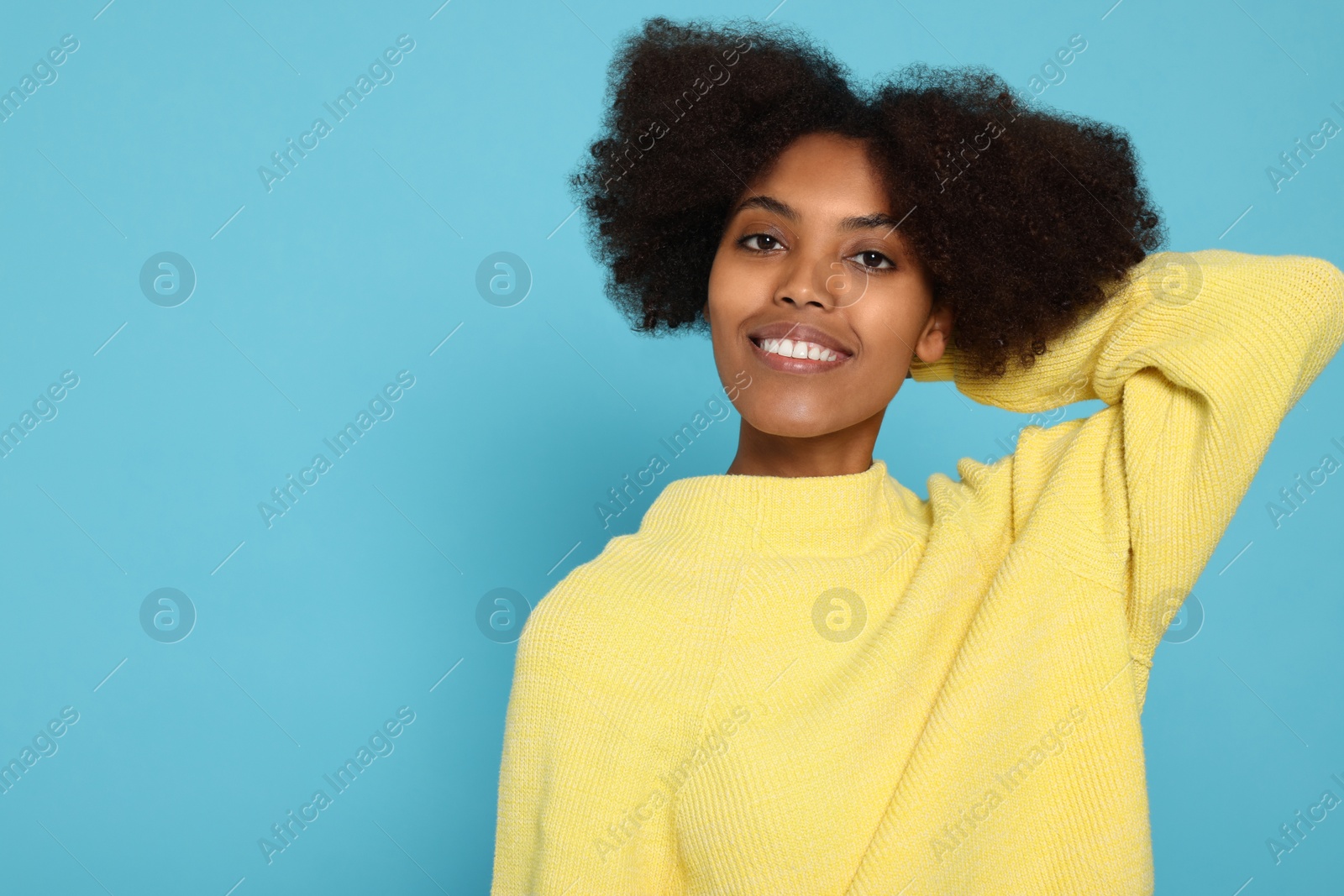 Photo of Portrait of smiling African American woman on light blue background. Space for text