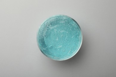 Photo of Jar of blue cosmetic gel on light background, top view